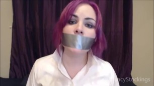 Purple haired girl talking with her mouth taped shut